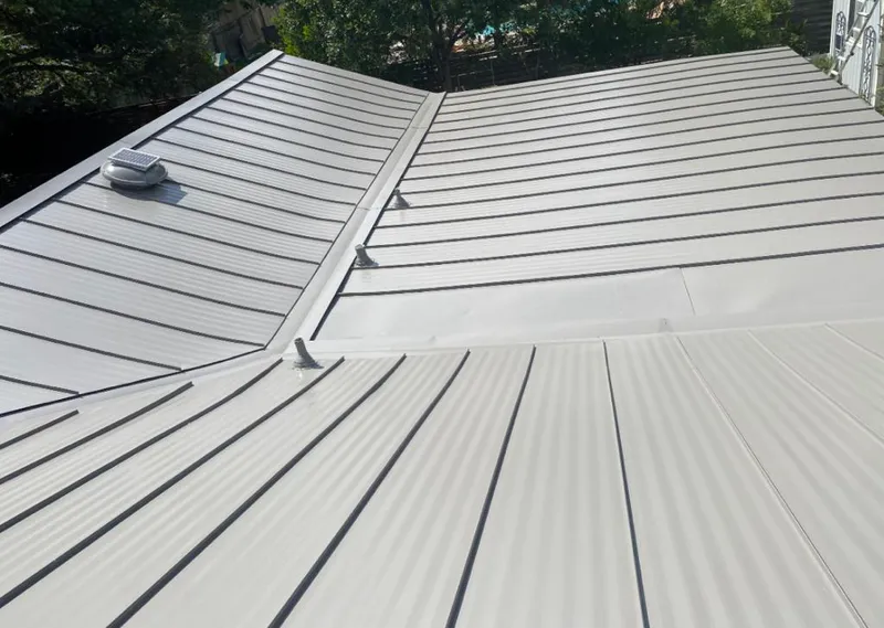Solar attic fan installed on a metal roof for Roof Ventilation in Baltimore